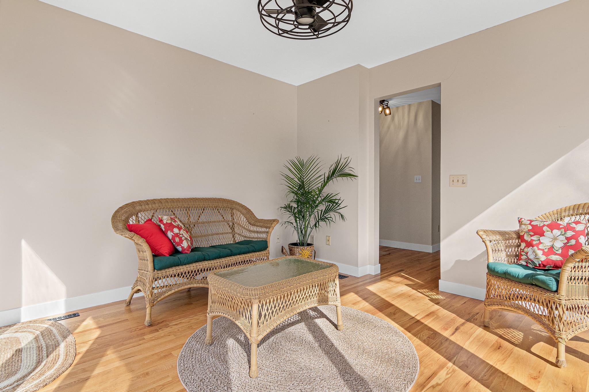 A couch and loveseat or recliner chair could easily fit in this space.