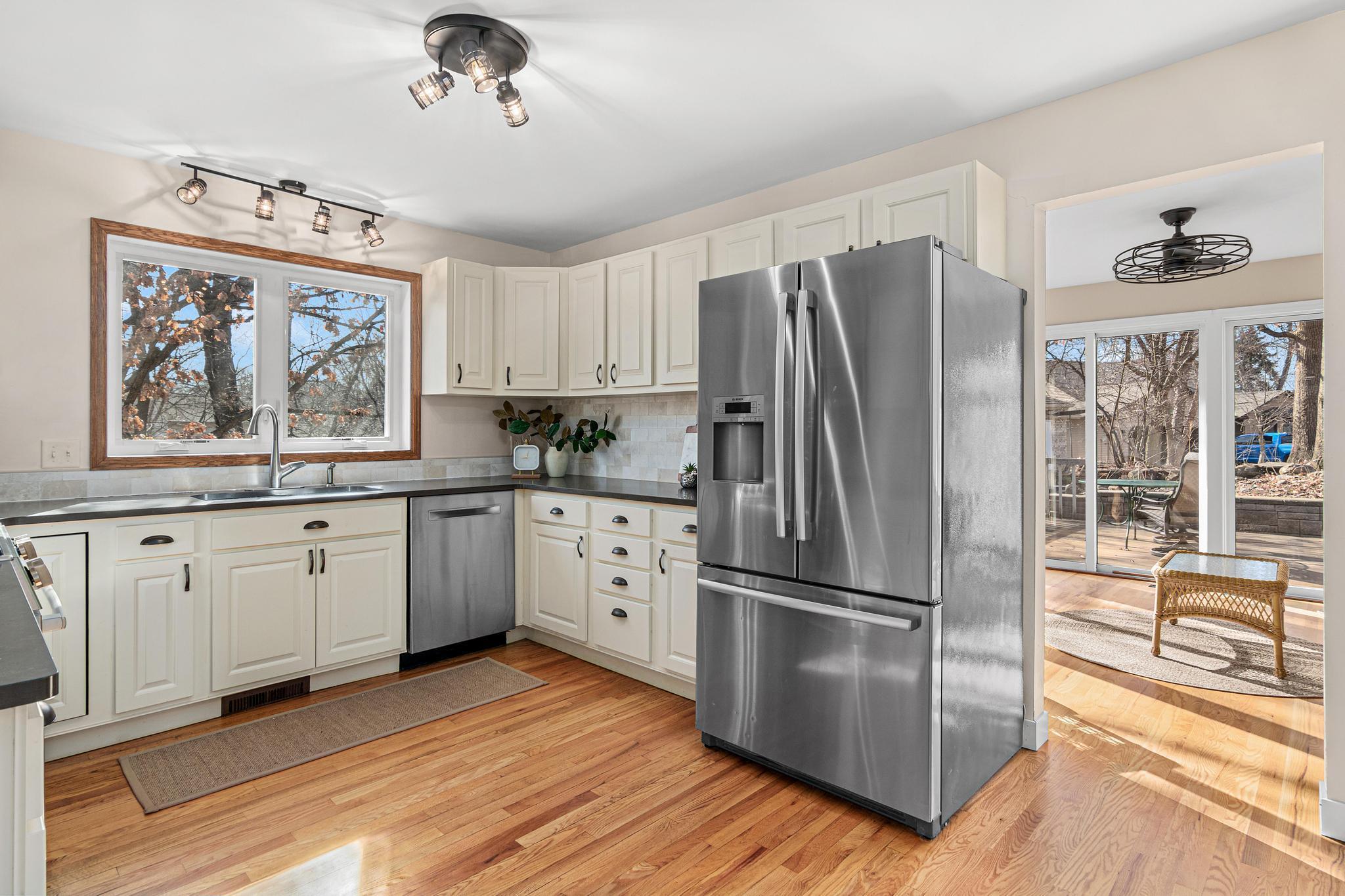 We love the large window above the kitchen sink and the proximity to the sunroom and attached garage. There is also a pantry closet next to the garage entrance.