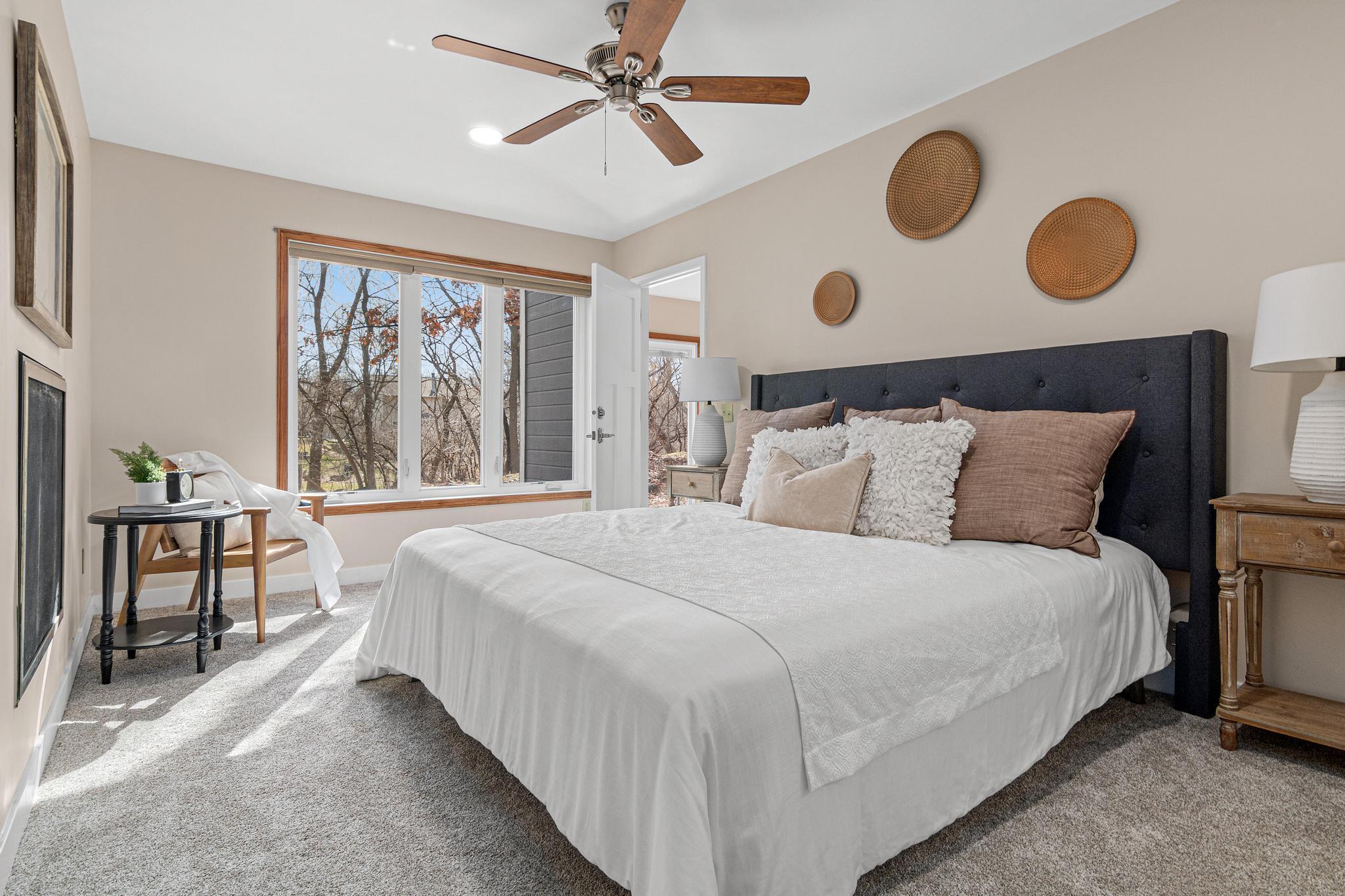 A king-sized bed and end tables fit easily in this primary bedroom.