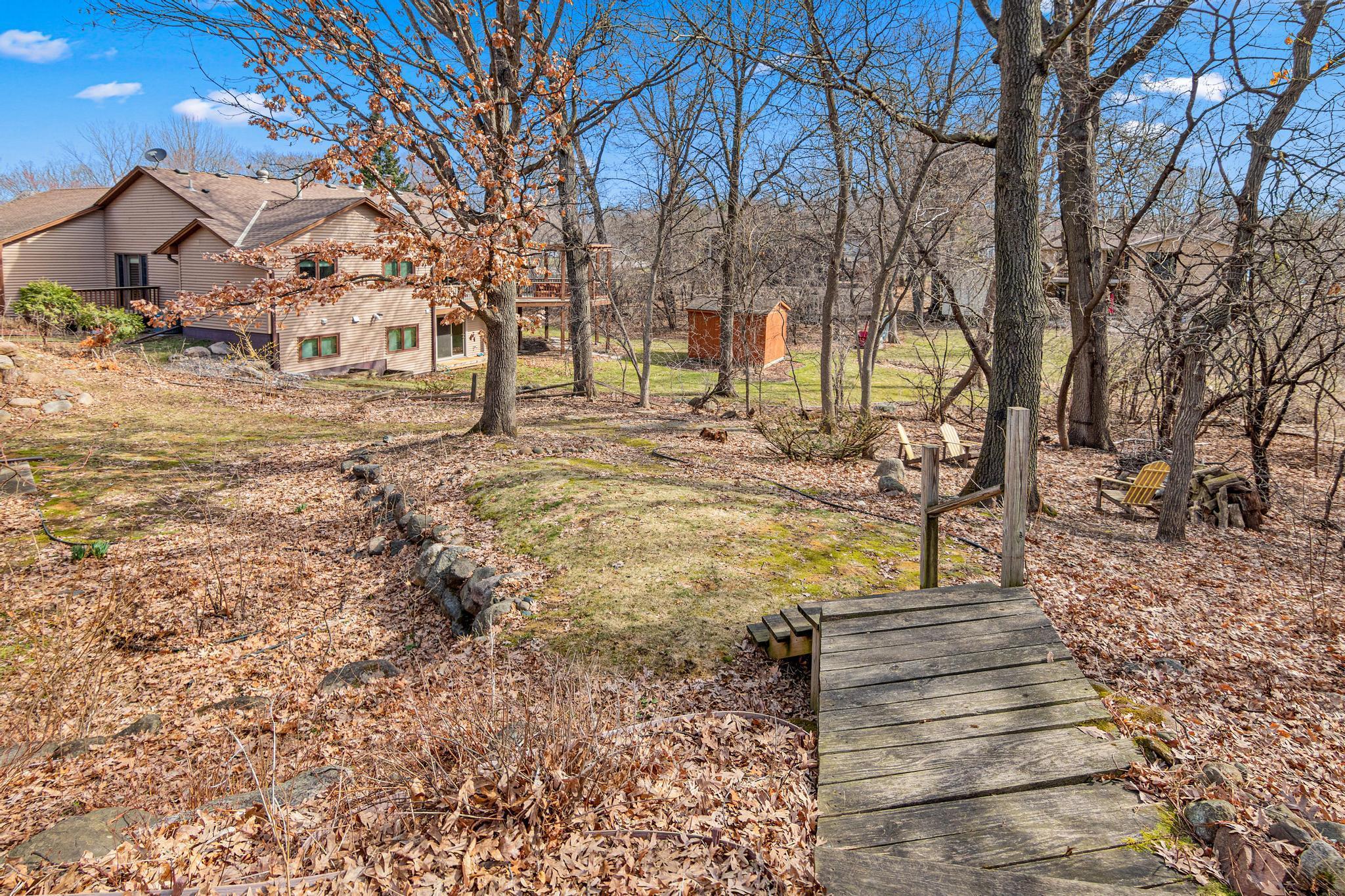 Steps leading down from the upper level deck. There is a fire pit seating area on the lower right side. Great place to relax and enjoy an evening outdoors!