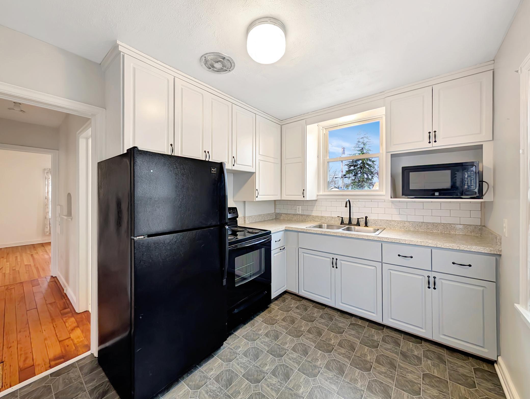 Kitchen is clean and features two windows for natural light!
