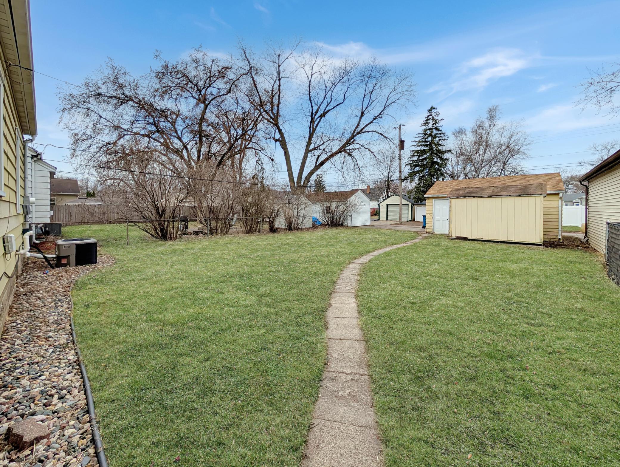 Spacious back yard with a concrete path!