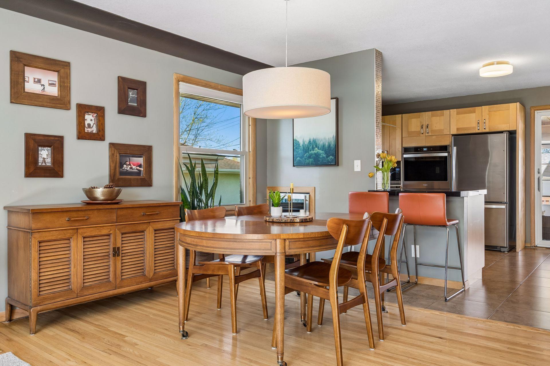 Dining room with updated lighting and bar refrigerator.