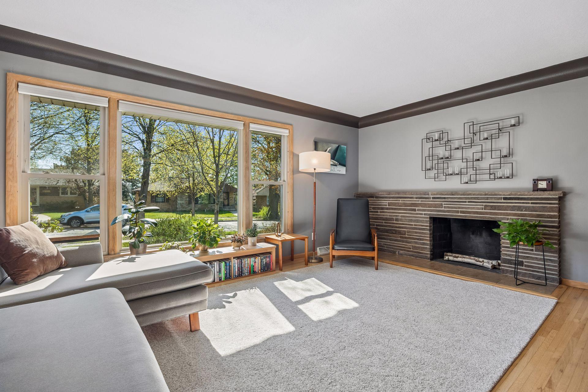 Bright and sunny living room with hardwood floor and open to the kitchen