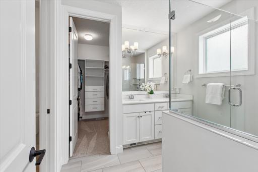 Pristine en suite bathroom with dual sinks