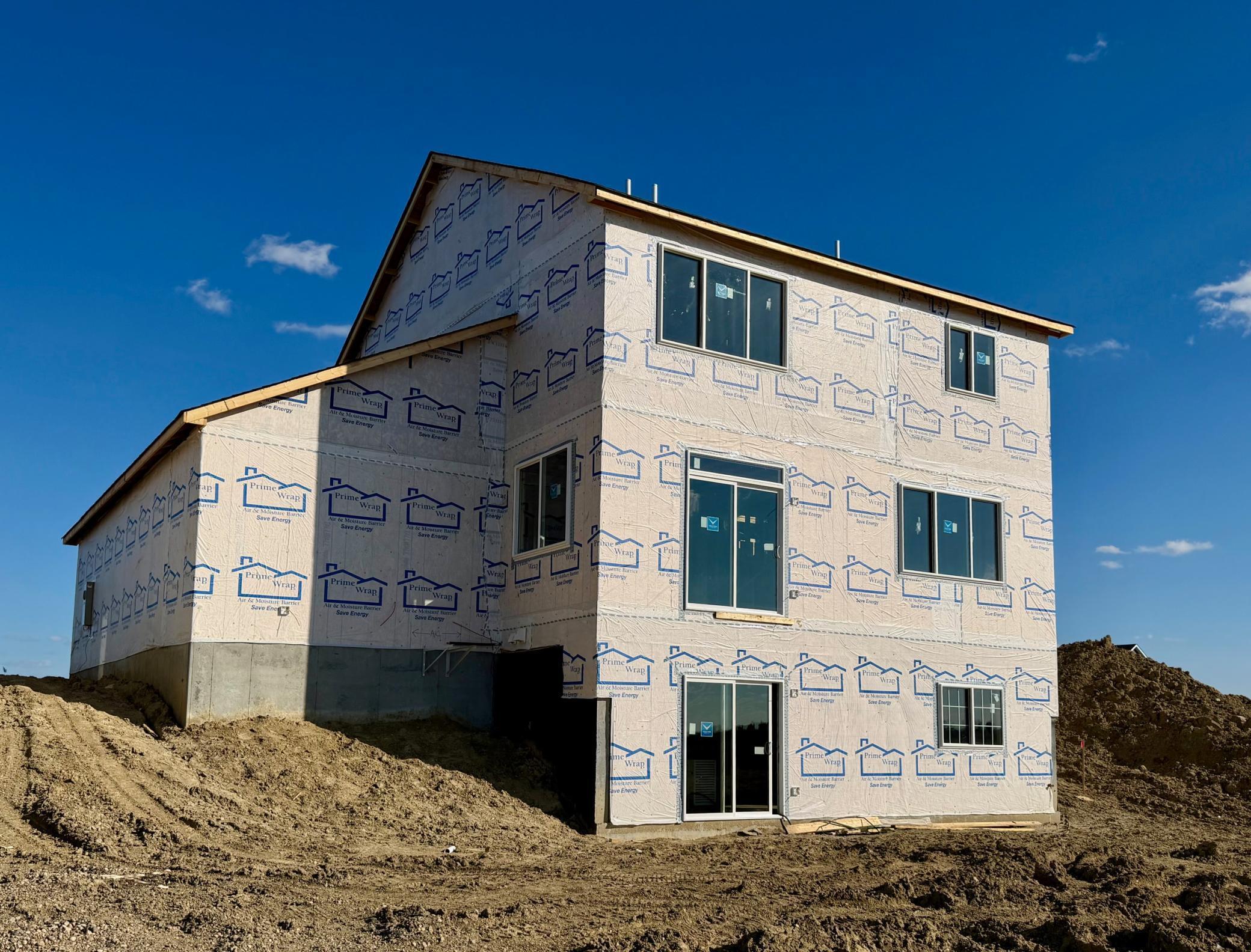 3153 Jandura Ave NE- Photo of actual home under construction. Rear elevation features a walkout lower level to a spacious backyard.