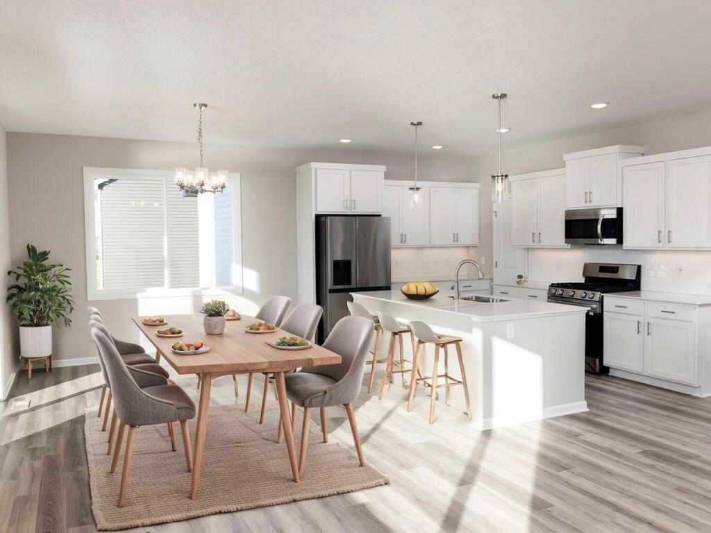 VIRTUALLY STAGED PHOTO OF A DIFFERENT HOME WITH SIMILAR PLAN. FINISHES MAY VARY. Dining Room/Kitchen