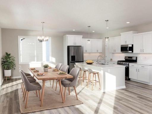 VIRTUALLY STAGED PHOTO OF A DIFFERENT HOME WITH SIMILAR PLAN. FINISHES MAY VARY. Dining Room/Kitchen