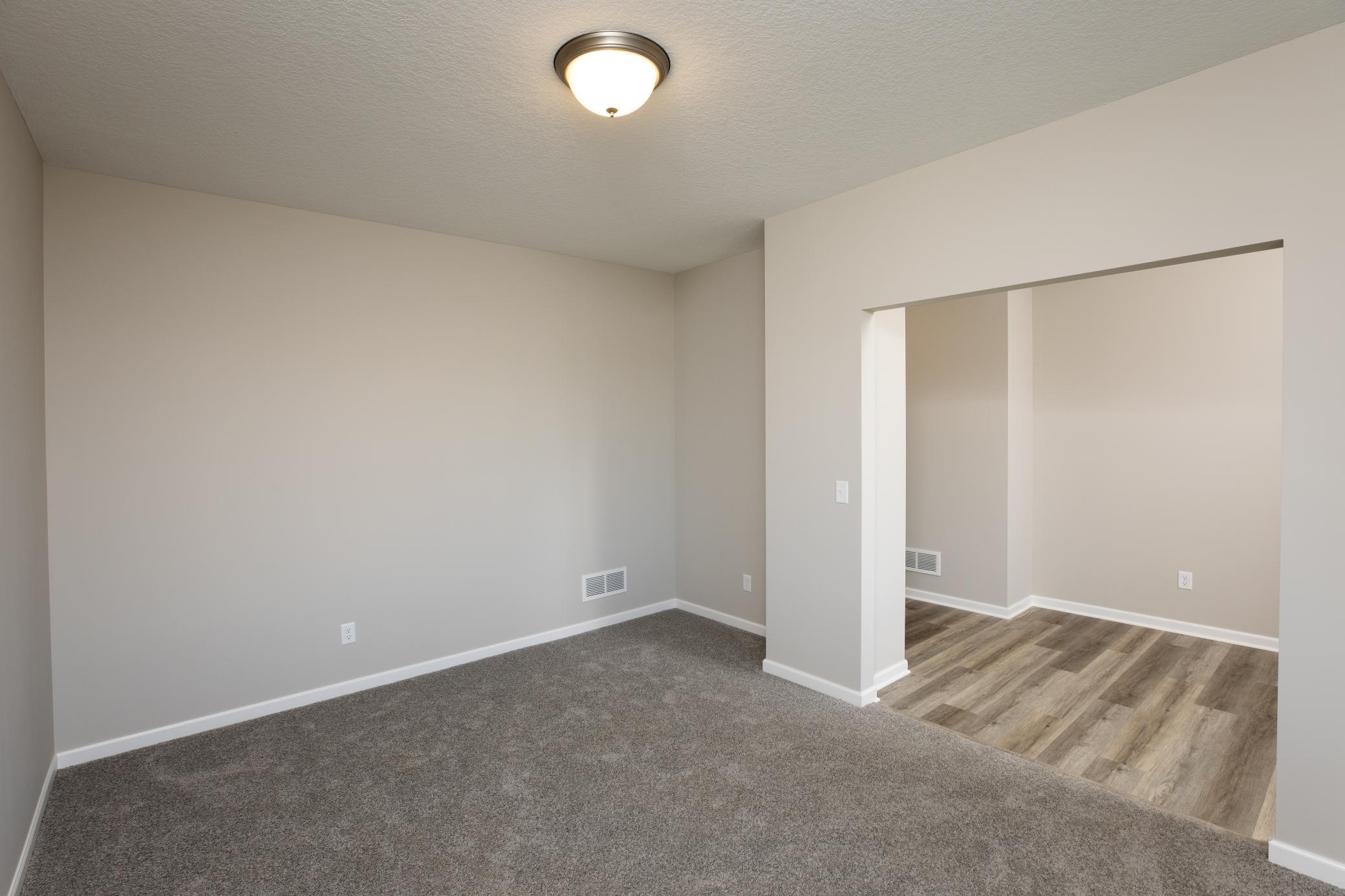 PHOTO OF A DIFFERENT HOME WITH SIMILAR PLAN. FINISHES MAY VARY. Main Floor Flex Room