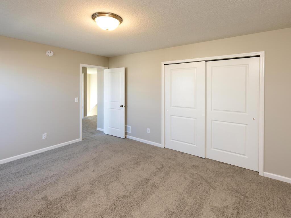 PHOTO OF A DIFFERENT HOME WITH SIMILAR PLAN. FINISHES MAY VARY. Bedroom 2