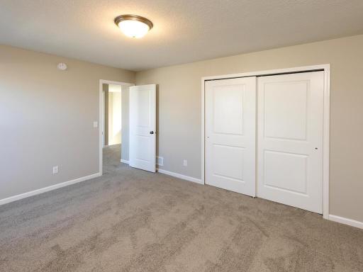 PHOTO OF A DIFFERENT HOME WITH SIMILAR PLAN. FINISHES MAY VARY. Bedroom 2