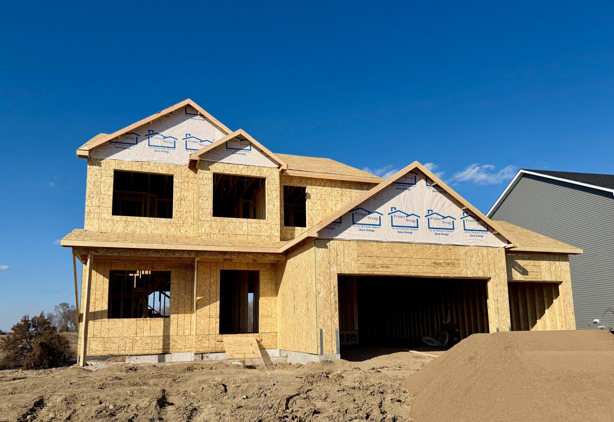 9674 32nd St NE - Photo of actual home under construction offering an estimated July move-in. Roofing and windows will be installed soon. Sod, Irrigation System, and Front Plantings included.