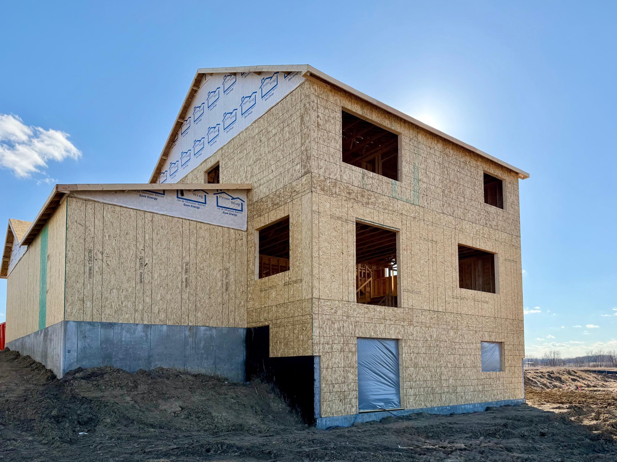 9674 32nd St NE- Photo of actual home under construction. Roofing and windows will be installed soon. Home features a Walkout Lower Level to the backyard.