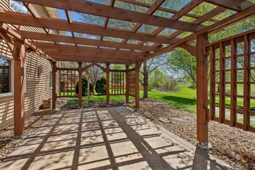 Large patio and pergola extend the home's outdoor dining and entertainment space