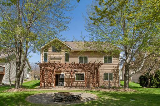 Lower-level walk out leads to beautiful, spacious pergola and backyard firepit