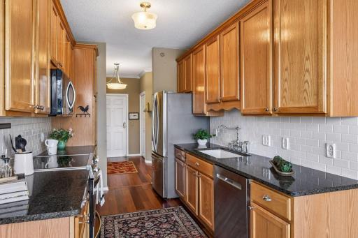 Granite countertops and stainless steel appliance boasting gorgegous hardwood flooring!