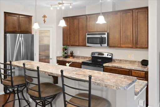 Functional kitchen with stainless steel appliances and abundant cabinetry.