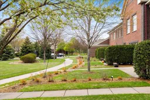 Is there a 3-bed townhome in Blaine MN under $320,000 with outdoor space? Yes. This private front patio with mature tree coverage offers a quiet place to relax while still enjoying low-maintenance living.