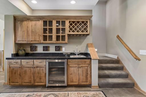 Lower level walk-up wet bar with beverage fridge