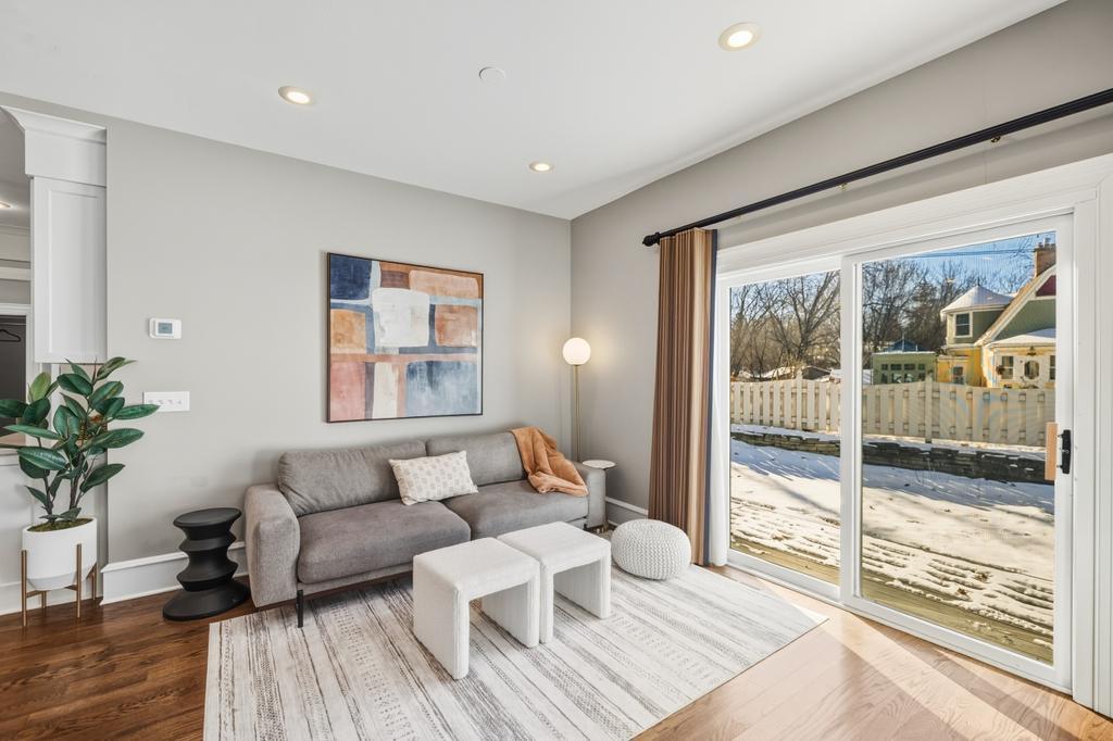 The living room sets the tone with warm hardwood floors and an easy, open feel.