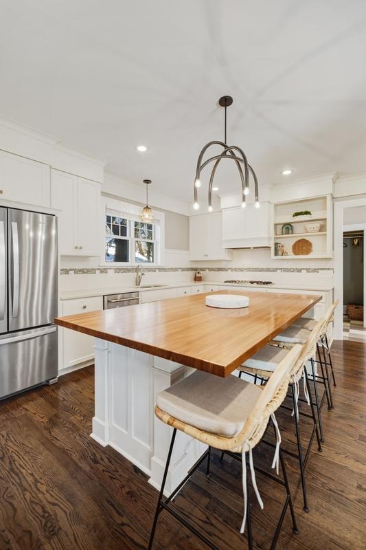 The kitchen offers generous counter space for preparing dinners after a day on the lake, arranging appetizers for summer gatherings, or hosting a leisurely weekend brunch.