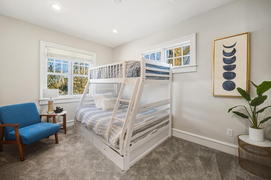 The second upper level bedroom is perfect as a guest space, home gym, or creative retreat.