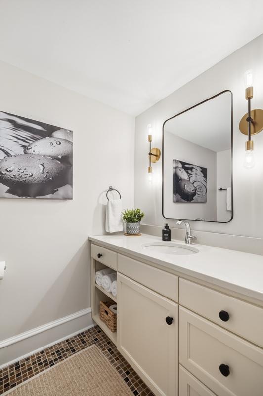 Bright and thoughtfully appointed, the shared upper-level bath offers a fresh, functional space designed to serve both bedrooms with ease and style.