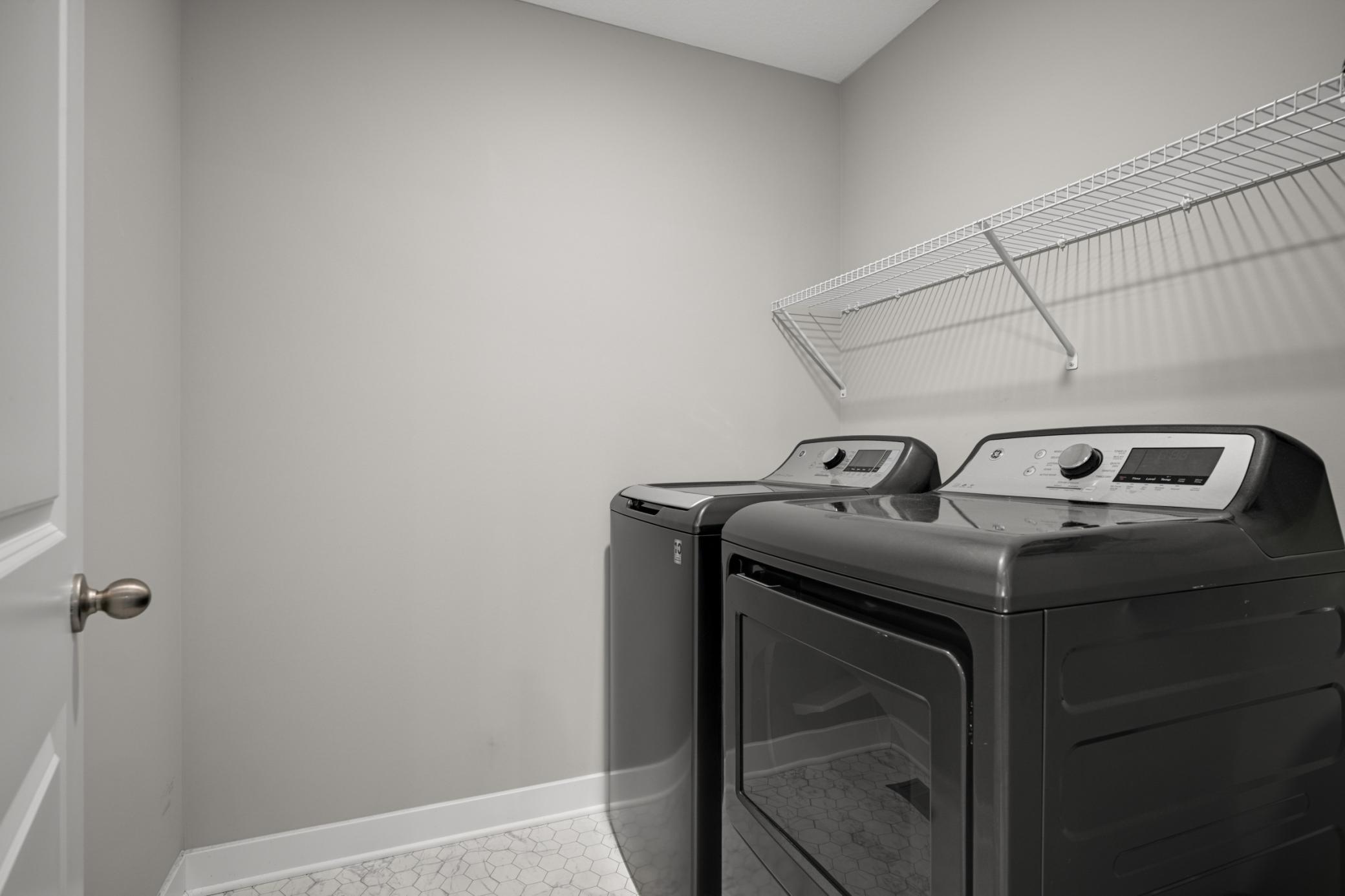 Upstairs Laundry Room with matching washer and dryer set