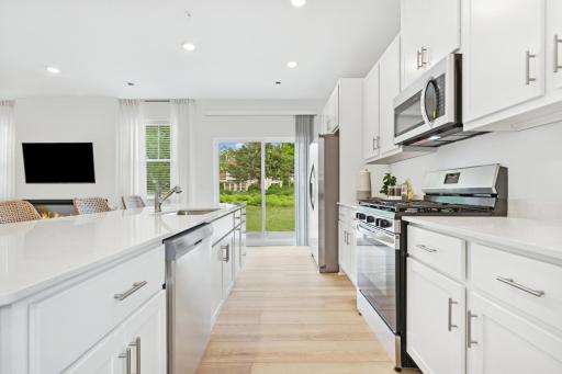 (Photo of model home, features will vary) A subway tile backsplash atop the 5-burner gas cooktop with an overhead microwave meets style with functionality