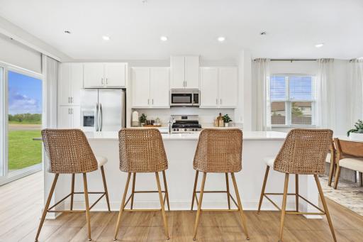 (Photo of model home, features will vary) This chef-ready kitchen is designed to accommodate modern living, with a multiuse center island to add food prep and seating space, gleaming quartz countertops and abundant cabinetry room.