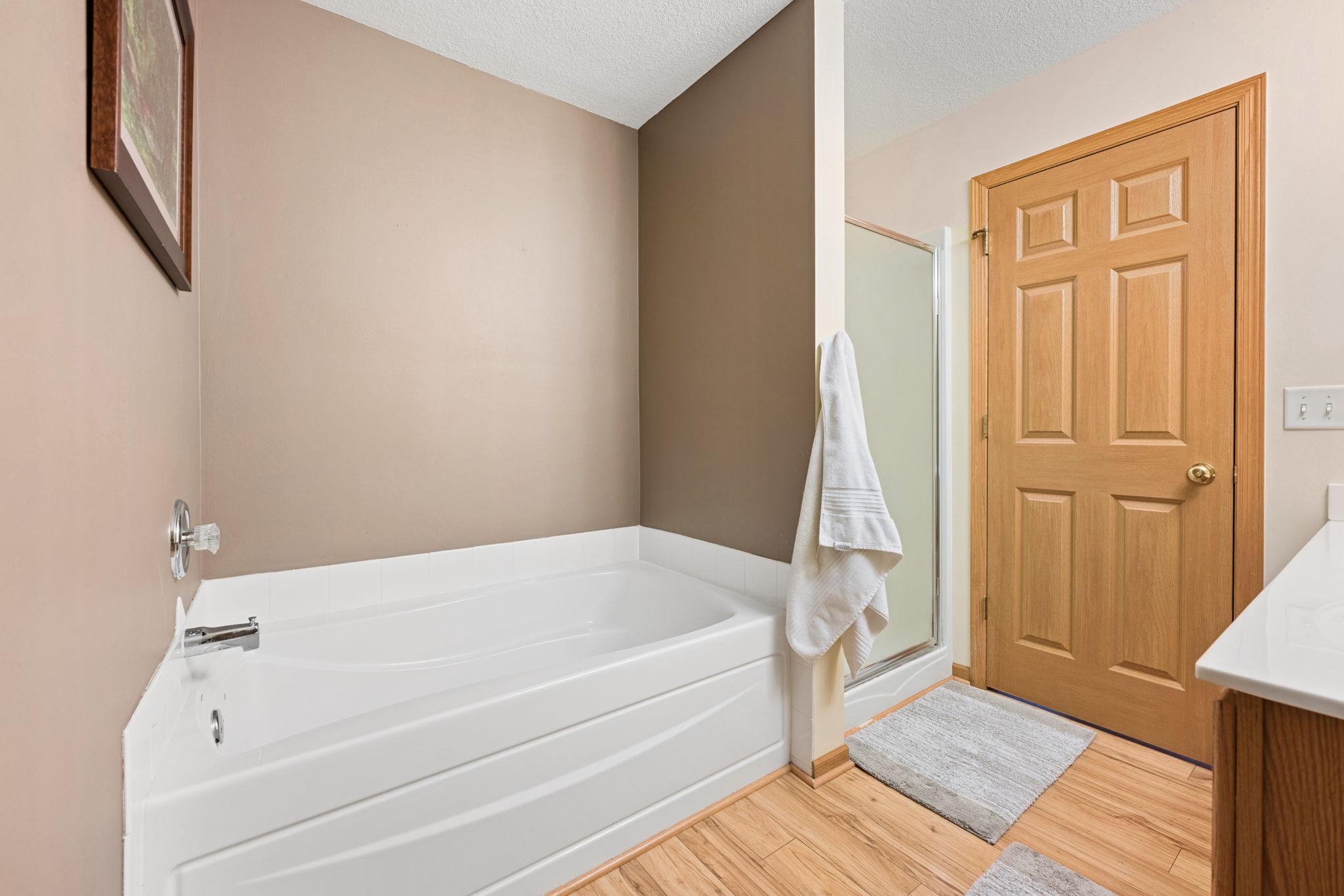 A full en-suite bath featuring a soaking tub and separate shower—perfect for both quick mornings and relaxed evenings.