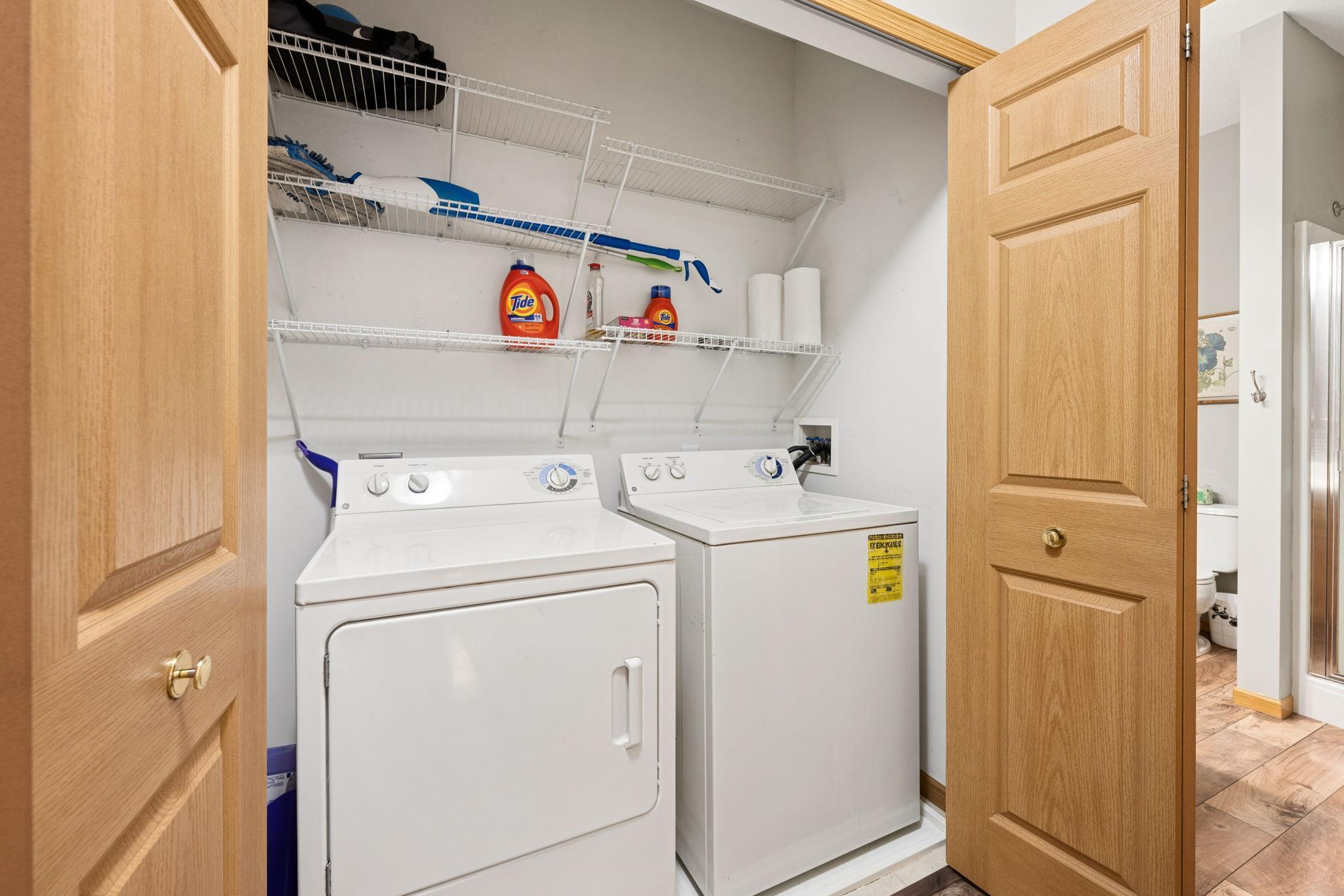 Convenient main-level laundry with dedicated storage—practical, functional, and tucked away from your main living areas.