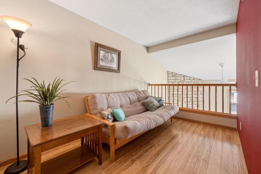 A bright and versatile loft spaceâperfect for a cozy reading nook, home office, or additional lounge area overlooking the main living space.
