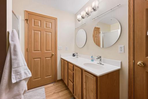 Double vanity with ample counter space and storage, designed to keep your routine organized and efficient, with dual access from both the primary bedroom and the loft/hallway for added convenience.