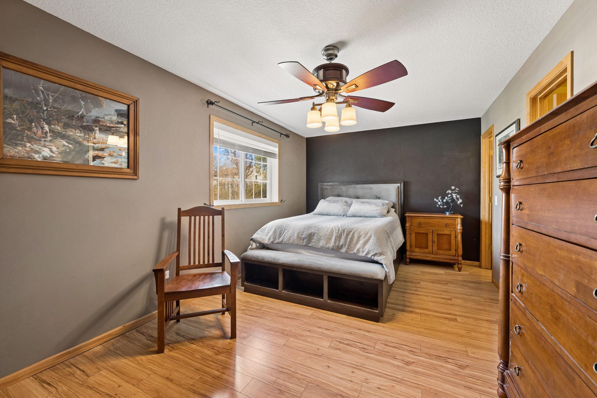 A spacious and inviting primary suite with warm tones, natural light, and plenty of room to unwind at the end of the day.