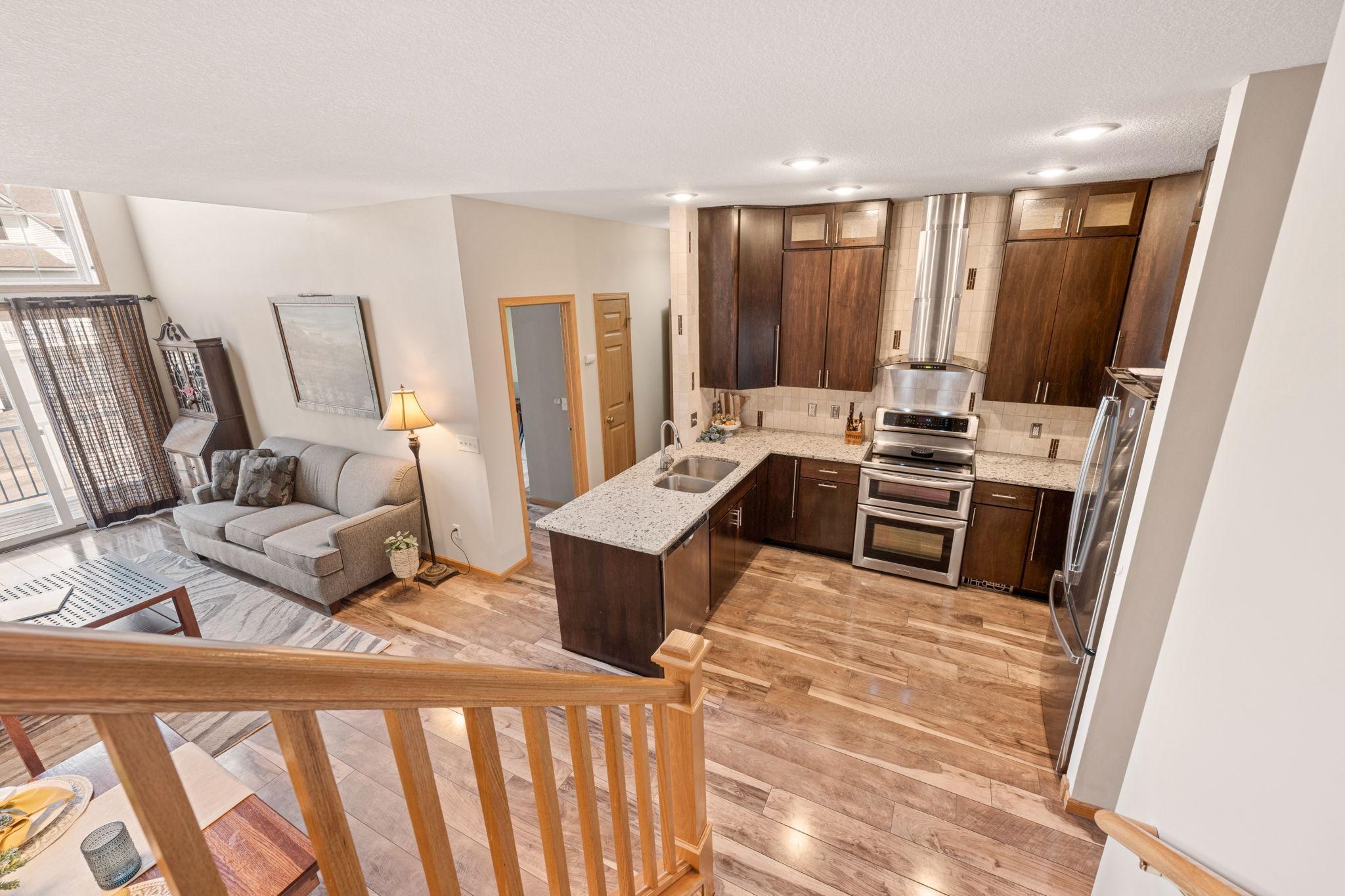 Seamless flow from kitchen and living area to upper level living space.