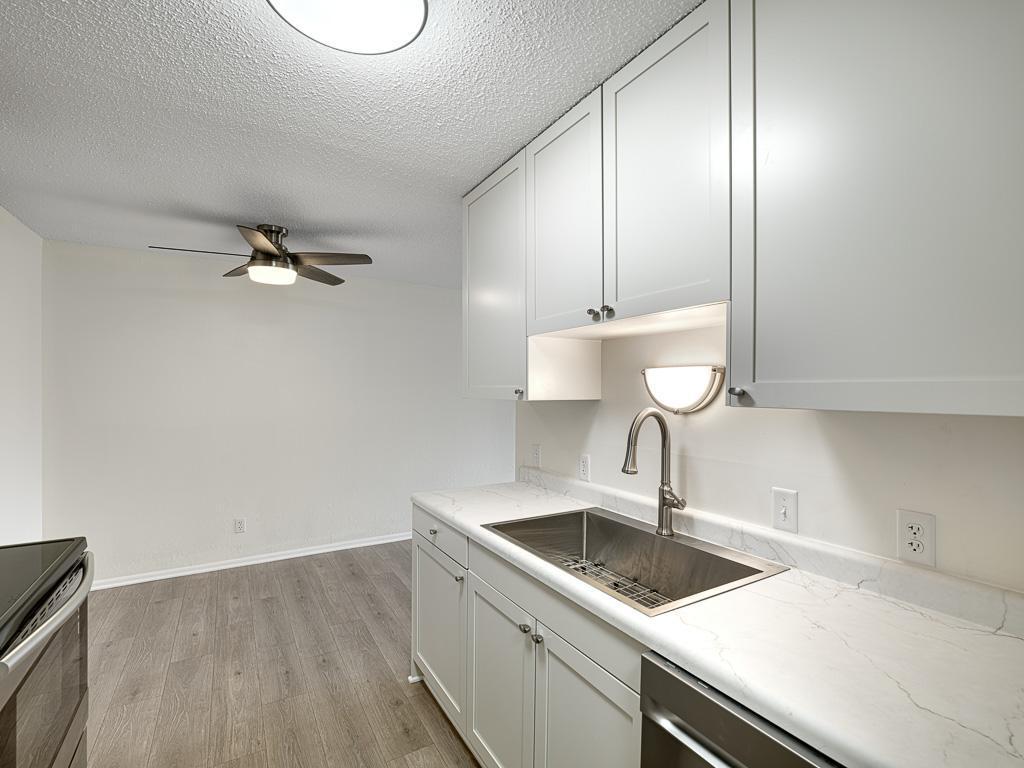 New light fixtures bring a modern flair to the kitchen and dining area.