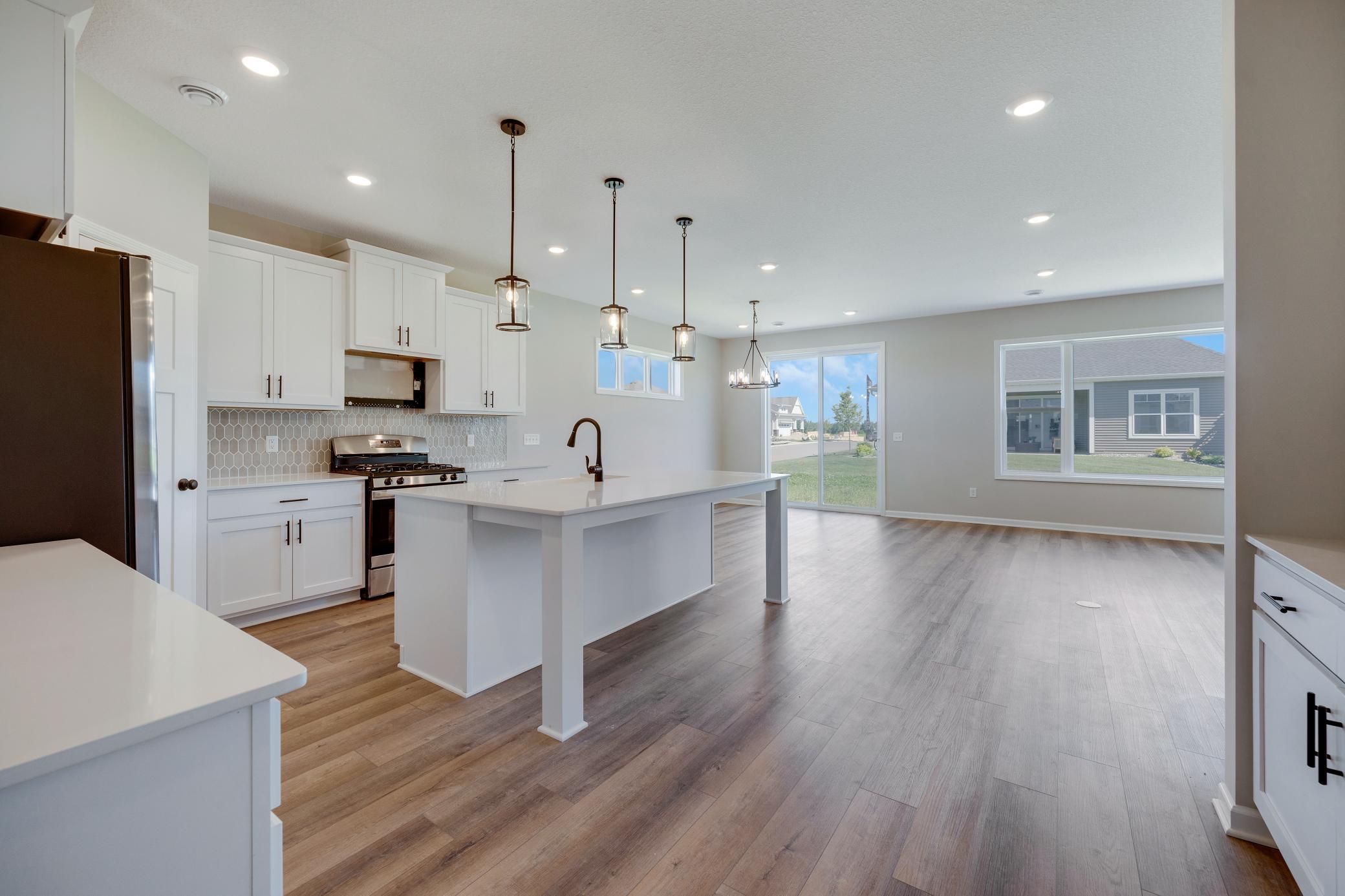 Great kitchen layout. Plenty of cabinet space and large island! Photo of similar home. Not actual home. Styles and finishes will vary.