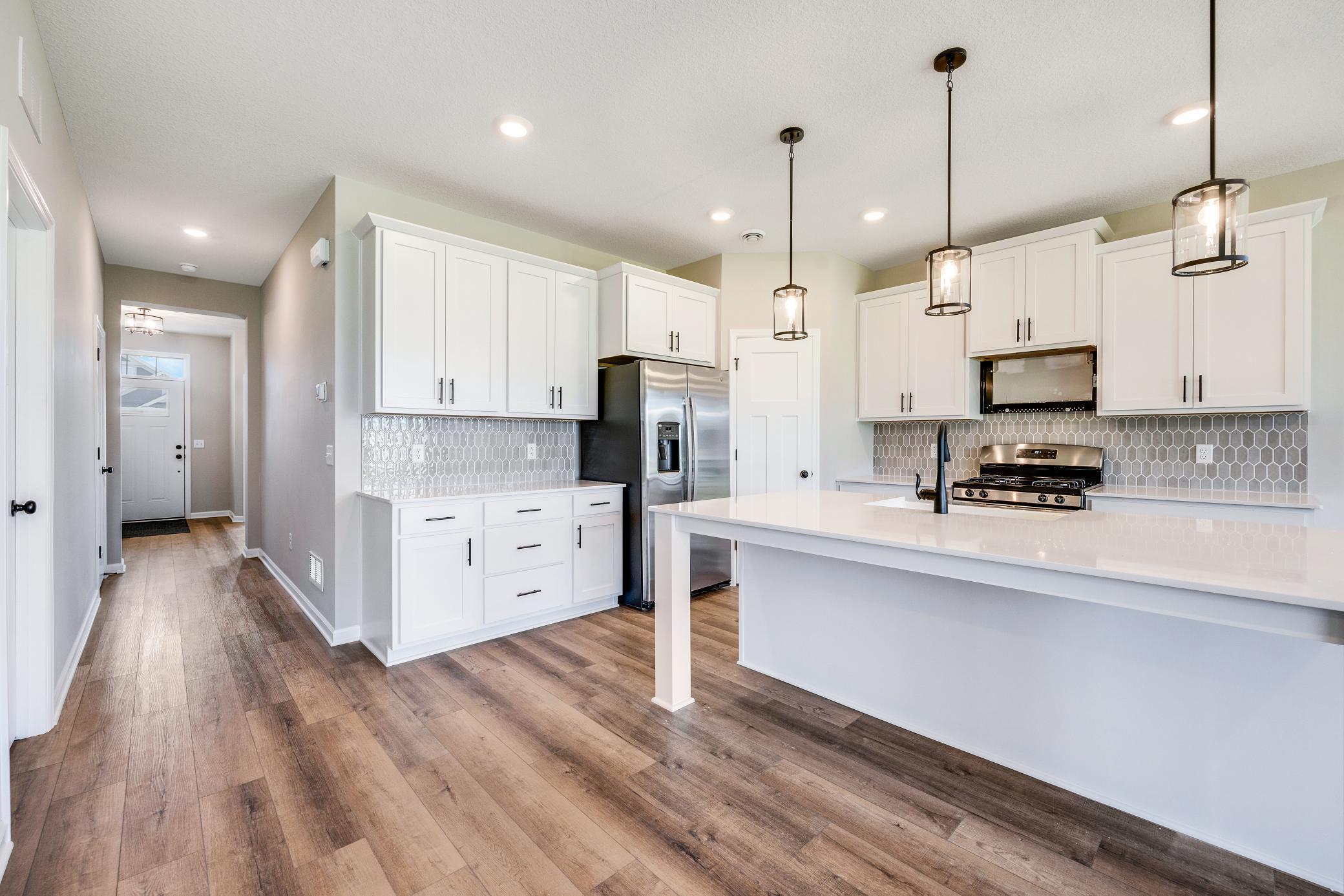 Another angle of the kitchen. Photo of similar home. Not actual home. Styles and finishes will vary.