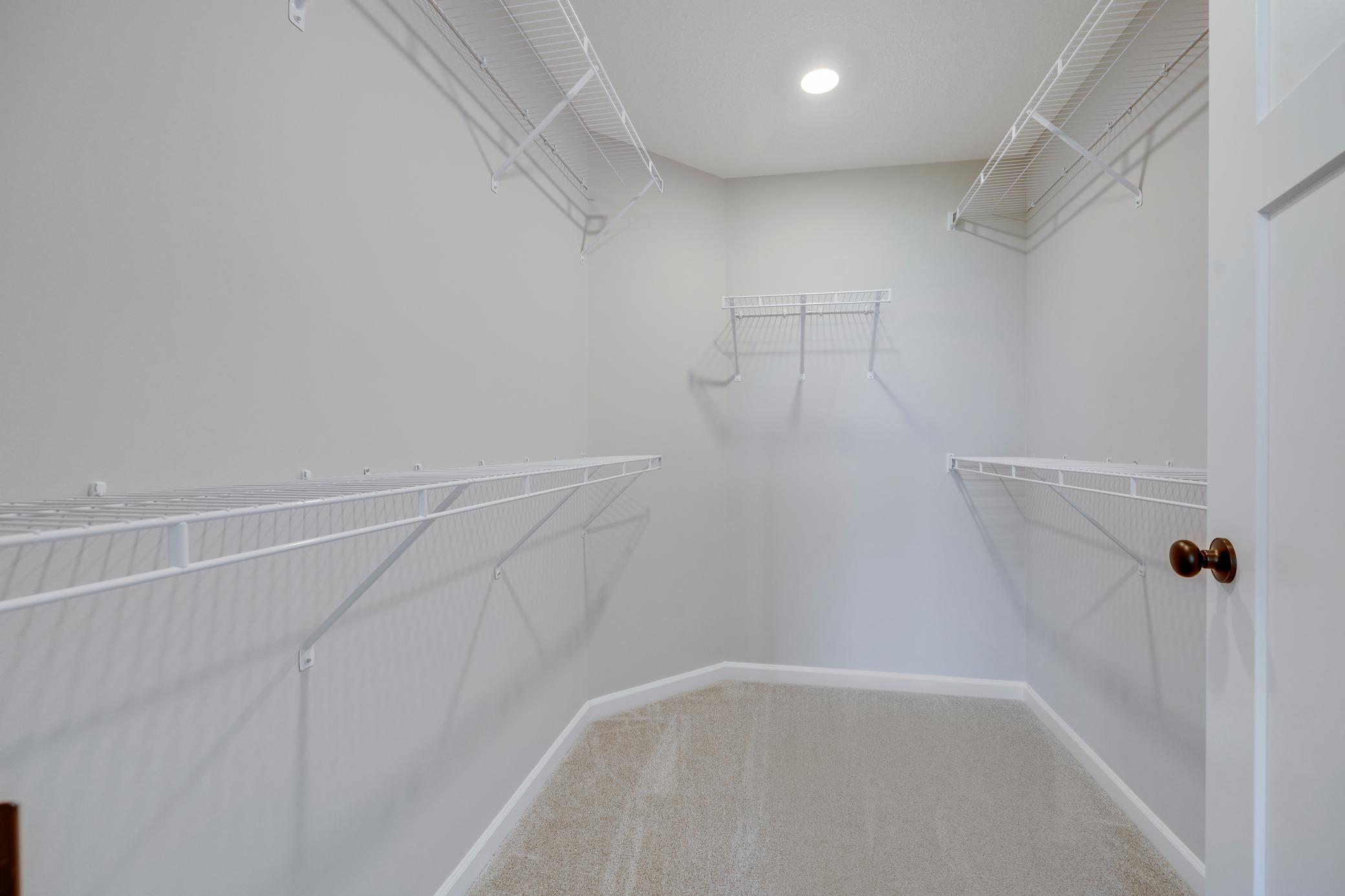 Large owner's closet. Photo of similar home. Not actual home. Styles and finishes will vary.