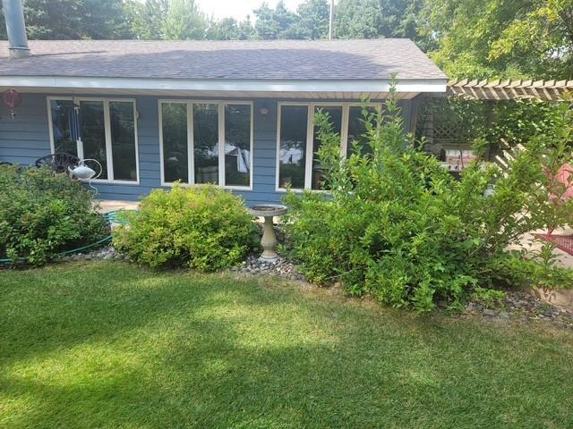 The home has so many windows looking to the lake along with so much green space.