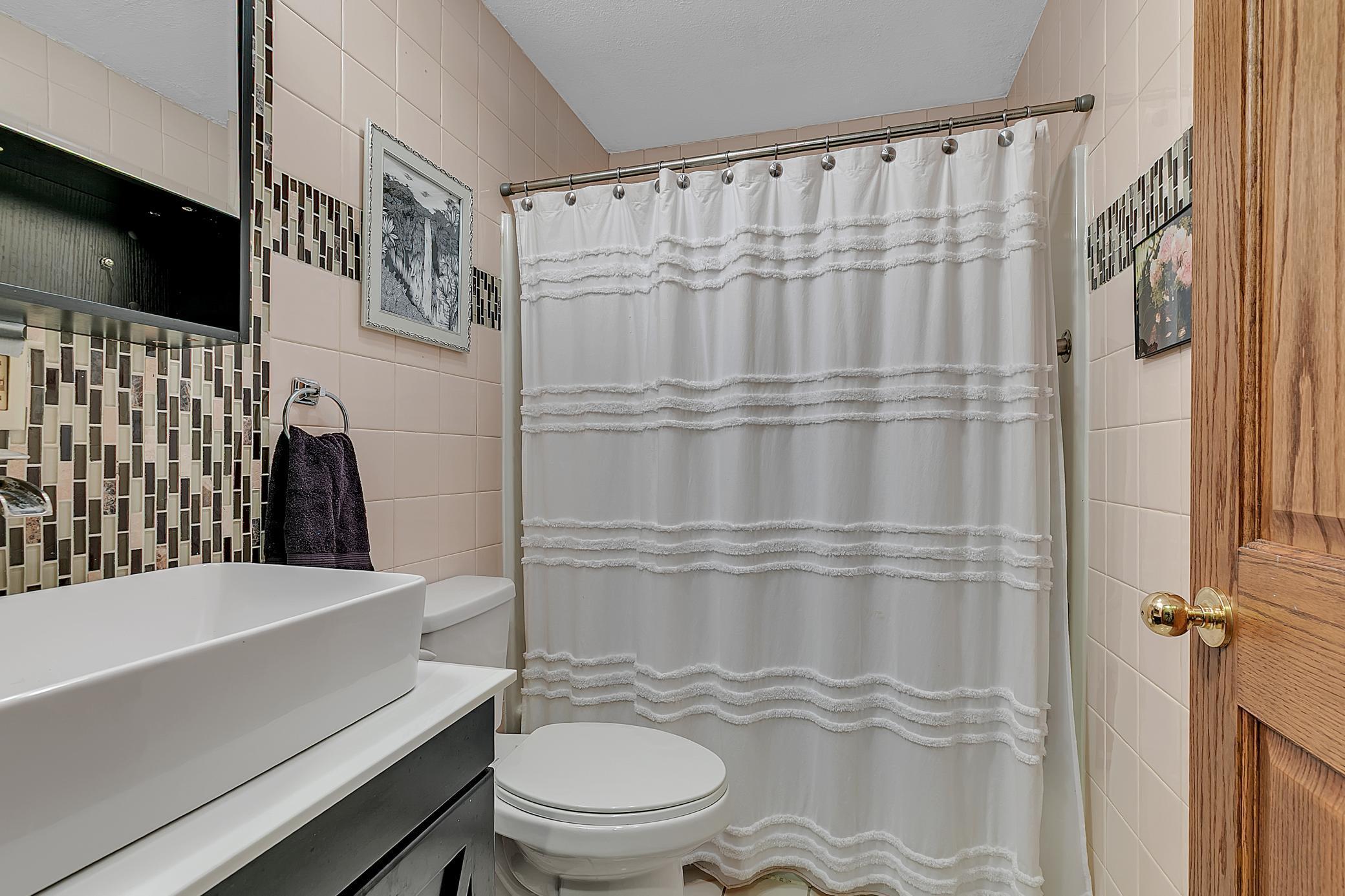 The main full bathroom has tiled walls.