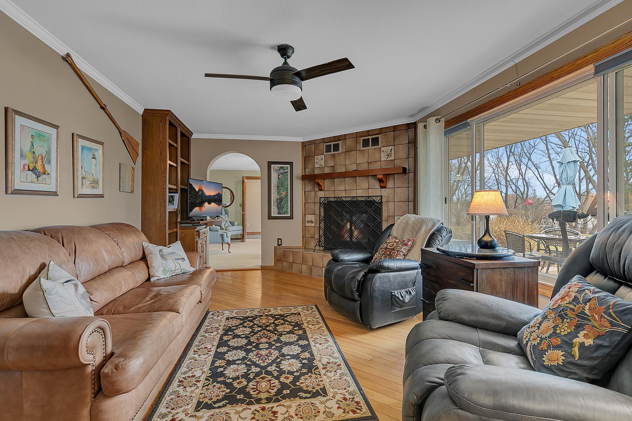 There is a fireplace, built-in bookcase along with those amazing views. This is a great space to relax, read, or entertain in. The arched doorway leads to the living room.