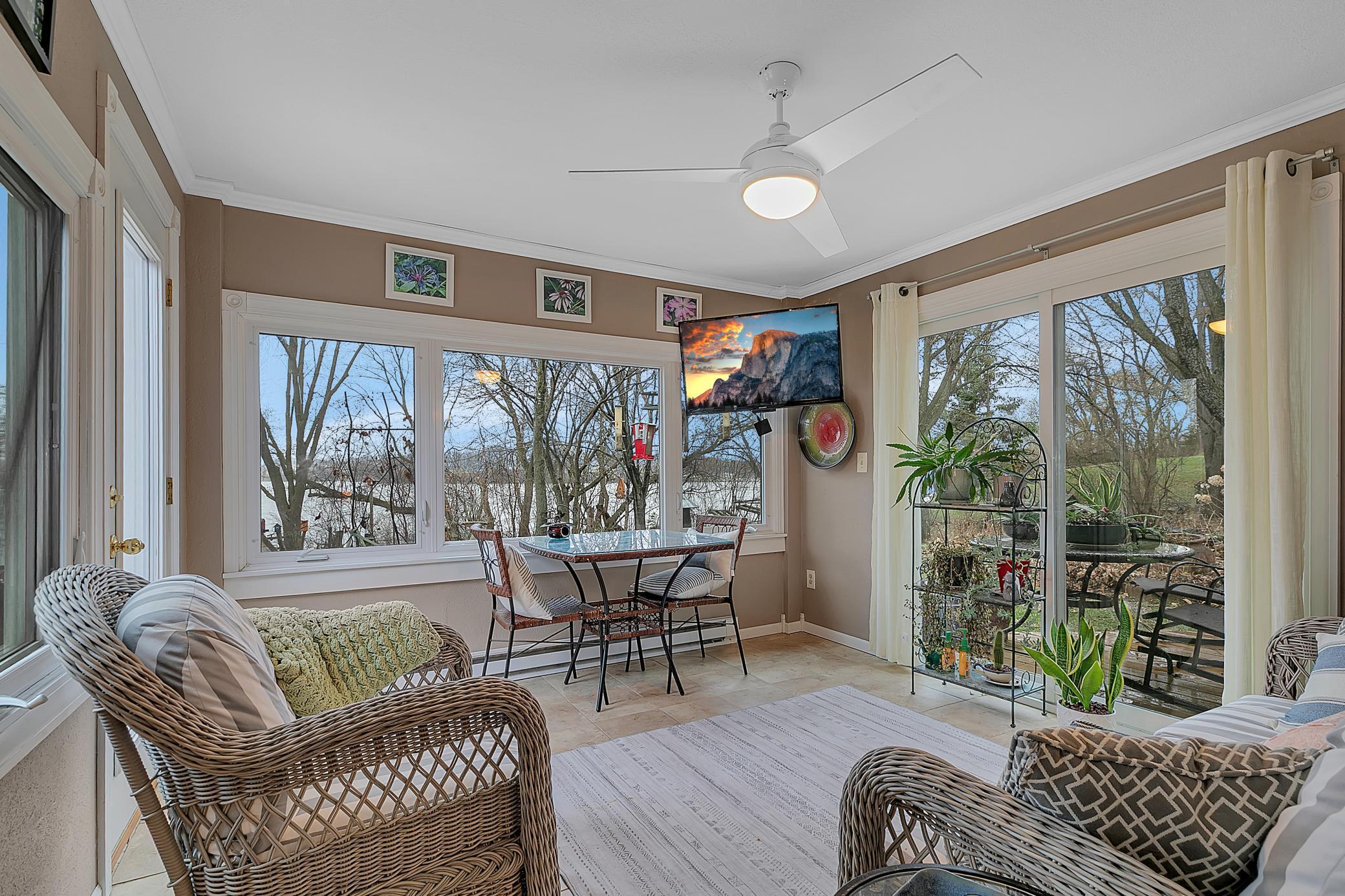 The sunroom is so relaxing. The lake views and nature views are spectaculari. There is a french door and sliding door leading to separate decks. The crown molding is a special touch.