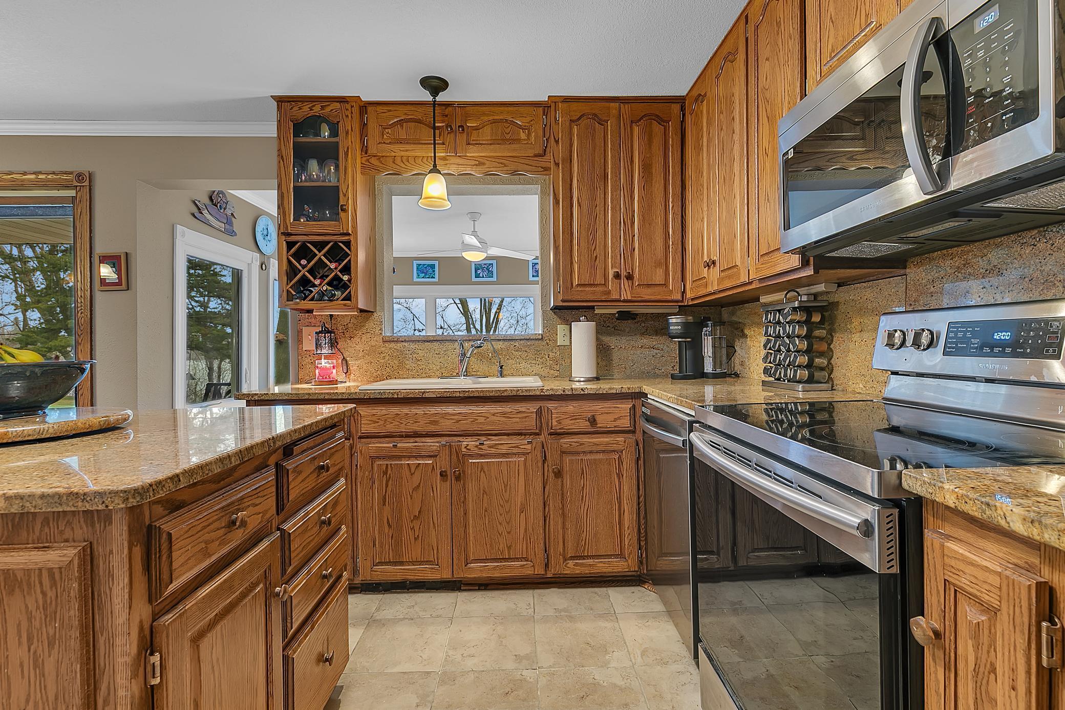 Beautiful woodwork throughout the home. The cutout over the sink looks into the sunroom.