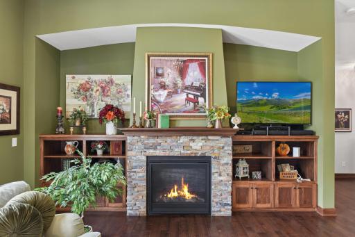 Cozy up to the gorgeous stone-wrapped fireplace surrounded by built-ins.