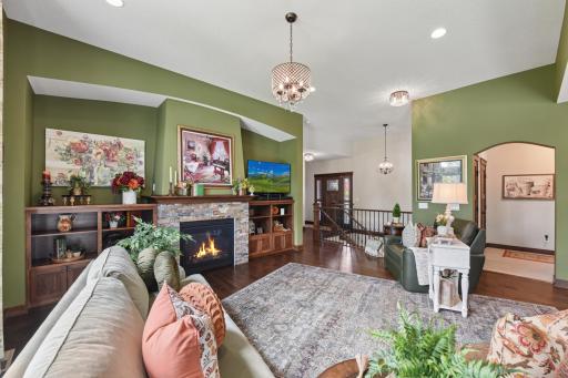 Stunning family room offers beautiful hardwood floors, high ceilings, and gorgeous natural lighting.