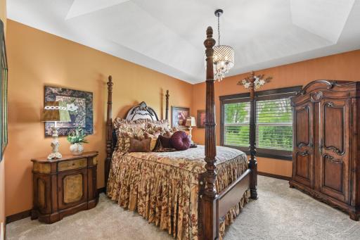 Main level primary bedroom is spacious with beautiful vaulted ceilings.