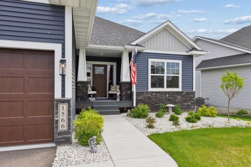 First impressions are everything and this one surely will not disappoint with the dark blue vinyl siding, upgraded garage doors and stone accents that lead up to a quaint front porch.