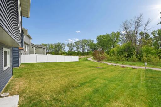 The spacious, flat backyard conveniently backs up to a local trail.